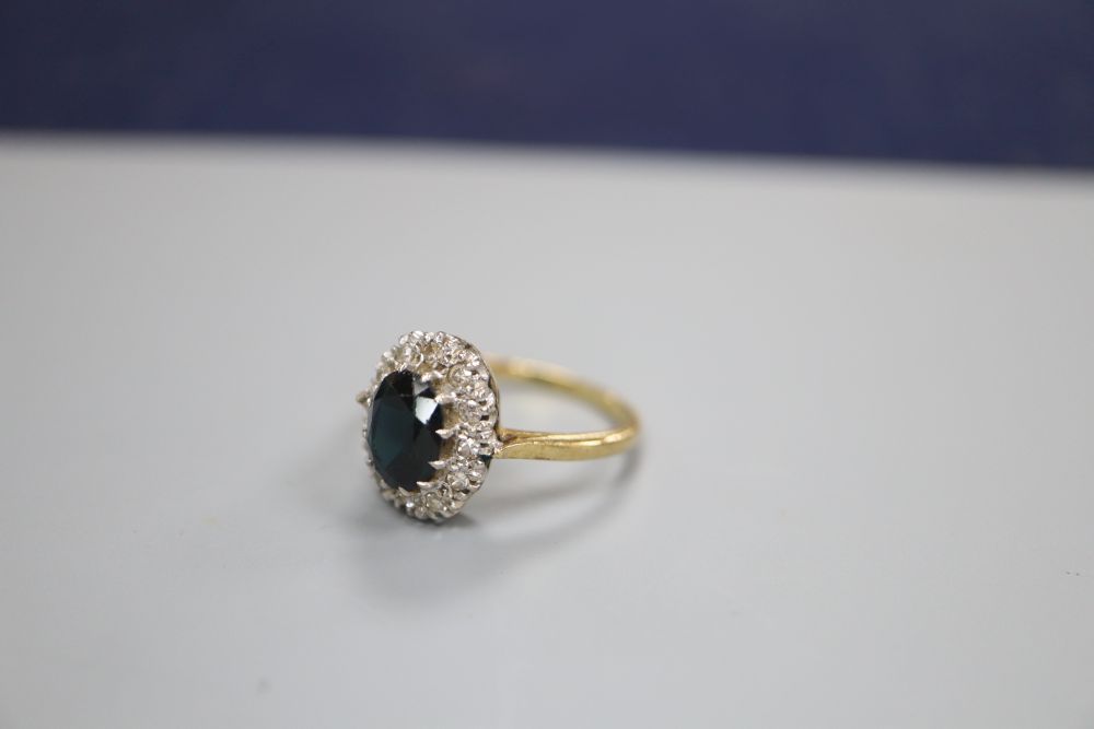 An 18ct gold diamond and sapphire ring, finger size N